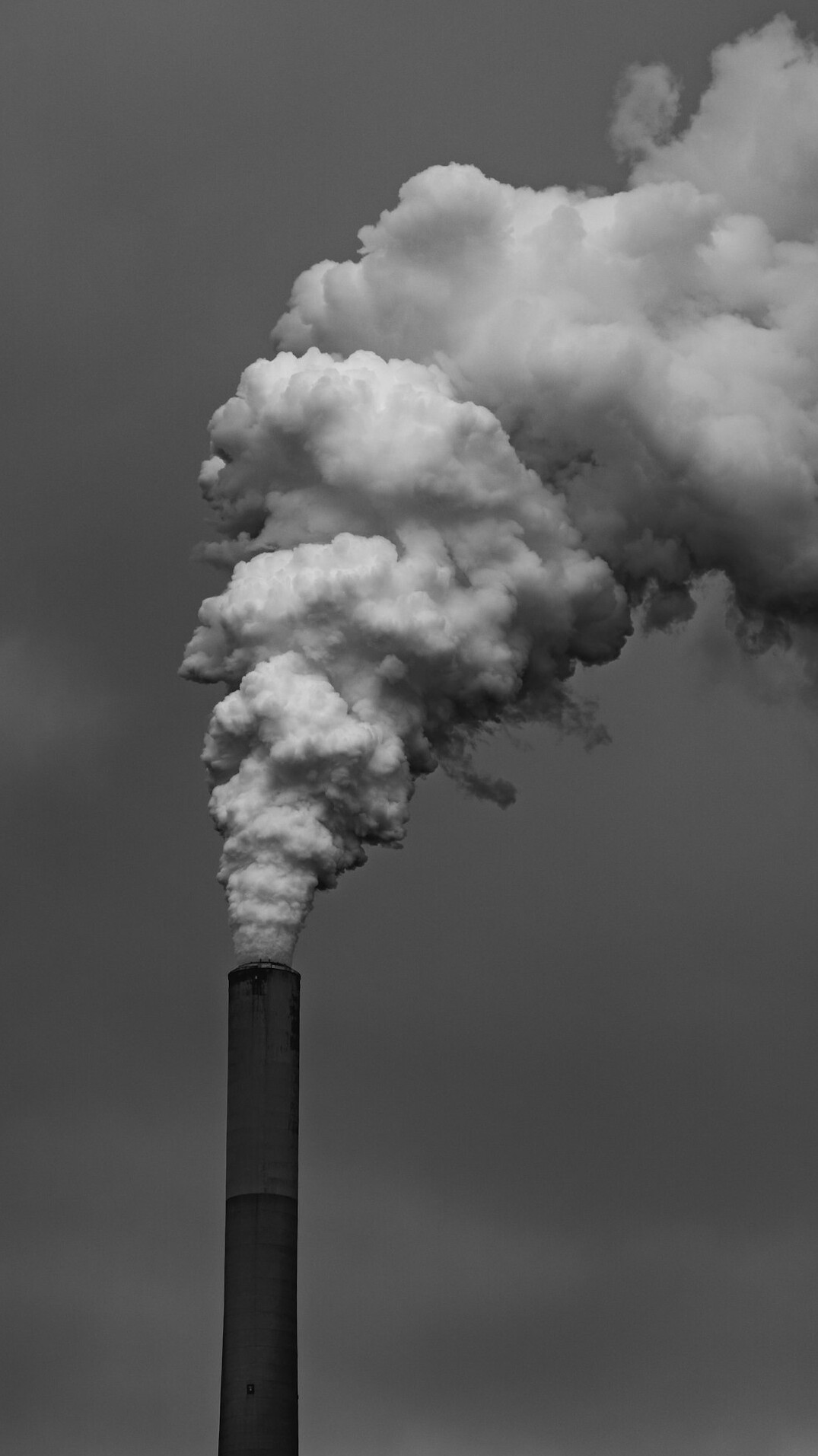 Industrial factory releasing smoke into the sky