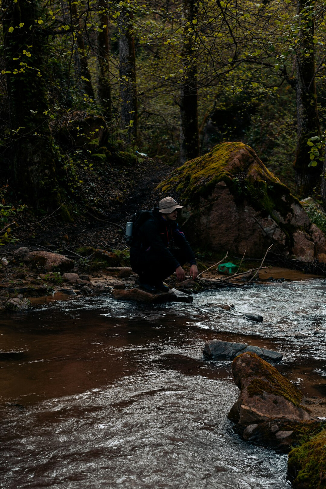 Researcher taking a water sample from a river