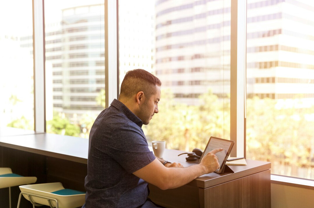 person using tablet in office